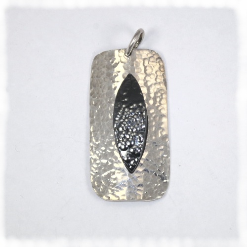 Silver dimpled pendant with haematite inset